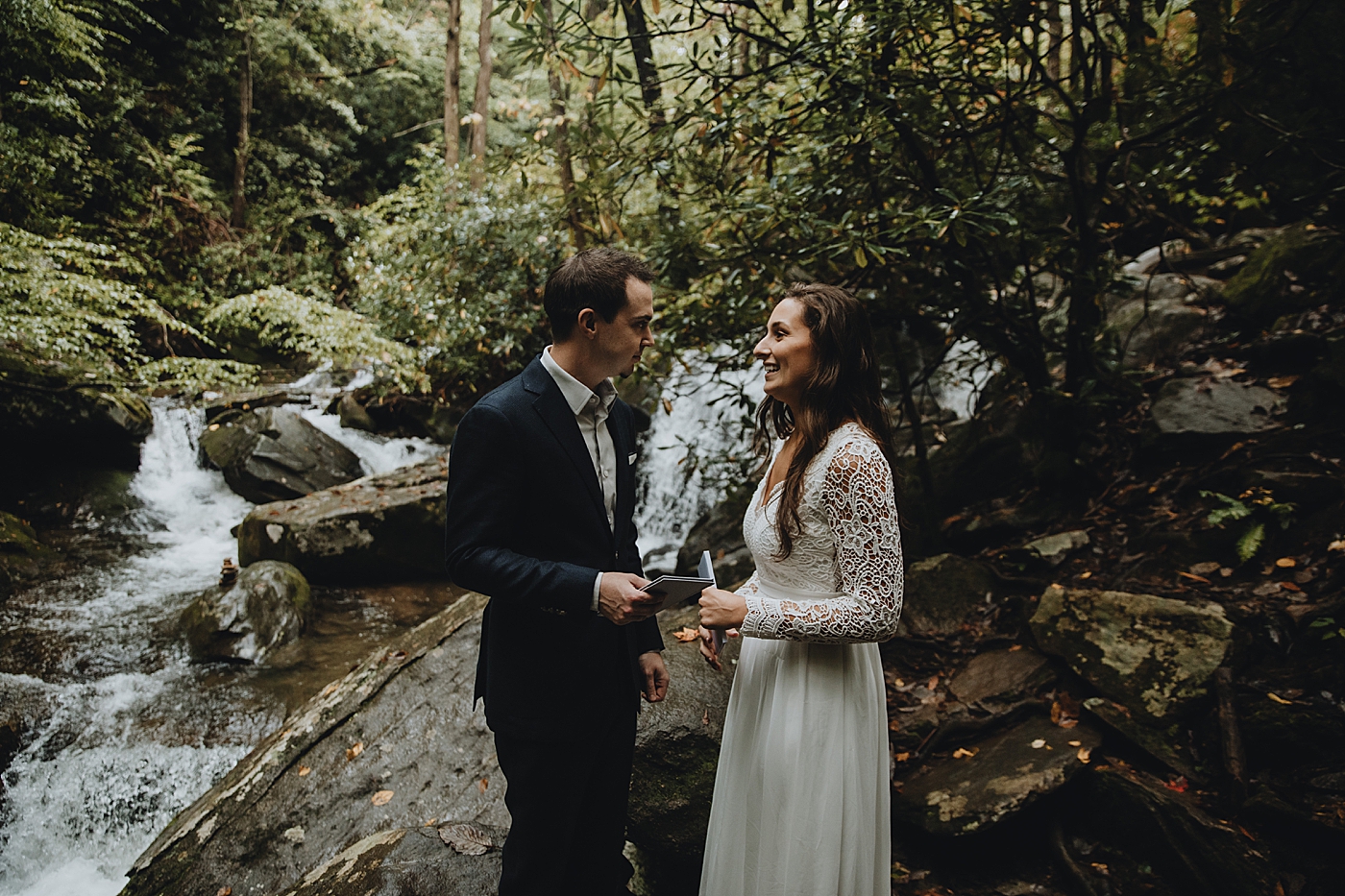Bride and Groom delivering vows in forest Catawba Falls Asheville, NC Elopement Photography captured by Maggie Alvarez Photography