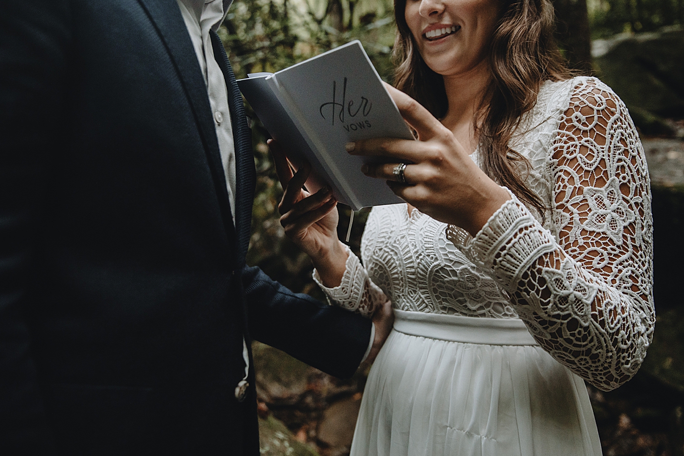 Bride delivering vows laughing closeup Catawba Falls Asheville, NC Elopement Photography captured by Maggie Alvarez Photography