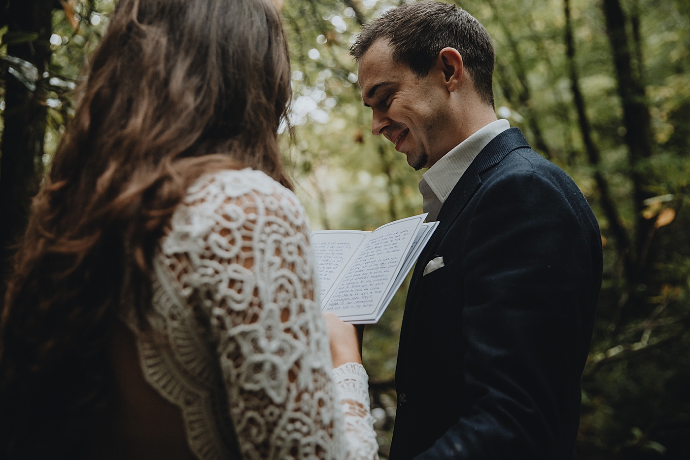 Groom smiling as Bride gives vows Catawba Falls Asheville, NC Elopement Photography captured by Maggie Alvarez Photography