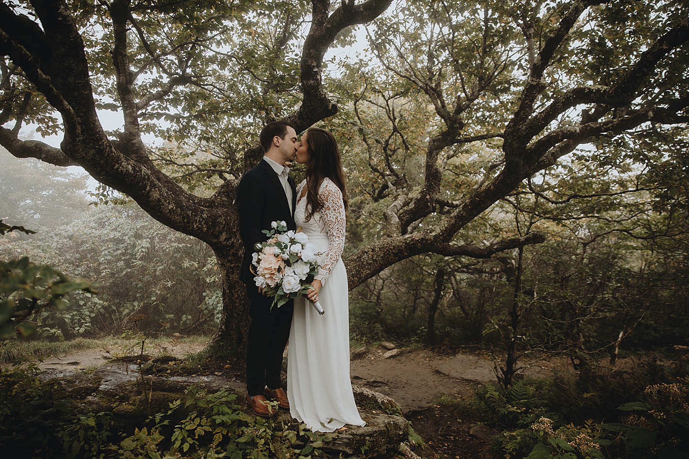 Bride and Groom kissing on front of tree Catawba Falls Asheville, NC Elopement Photography captured by Maggie Alvarez Photography