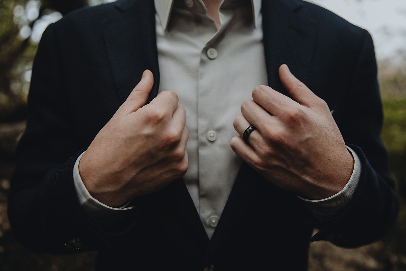 Closeup of Groom with wedding band and coat Catawba Falls Asheville, NC Elopement Photography captured by Maggie Alvarez Photography