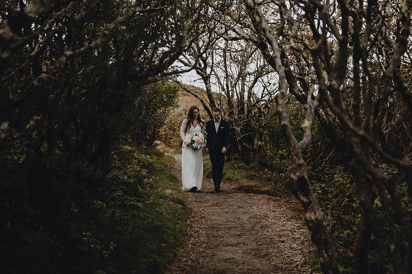 Bride and Groom walking down nature path Catawba Falls Asheville, NC Elopement Photography captured by Maggie Alvarez Photography