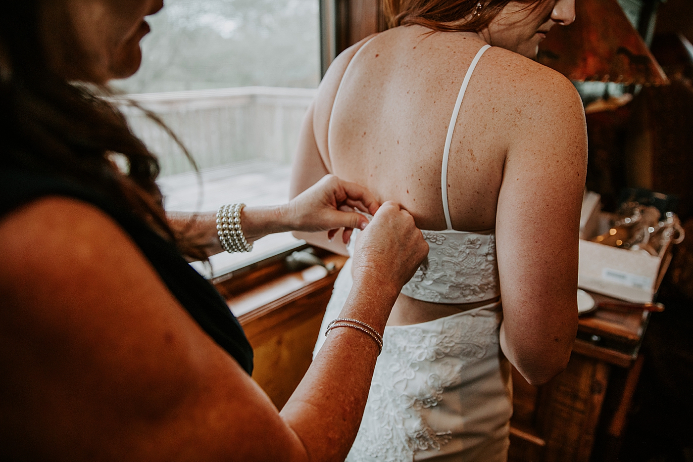 Bride getting help with her dress BMR Stables Wedding Photography captured by South Florida Wedding Photographer Maggie Alvarez Photography