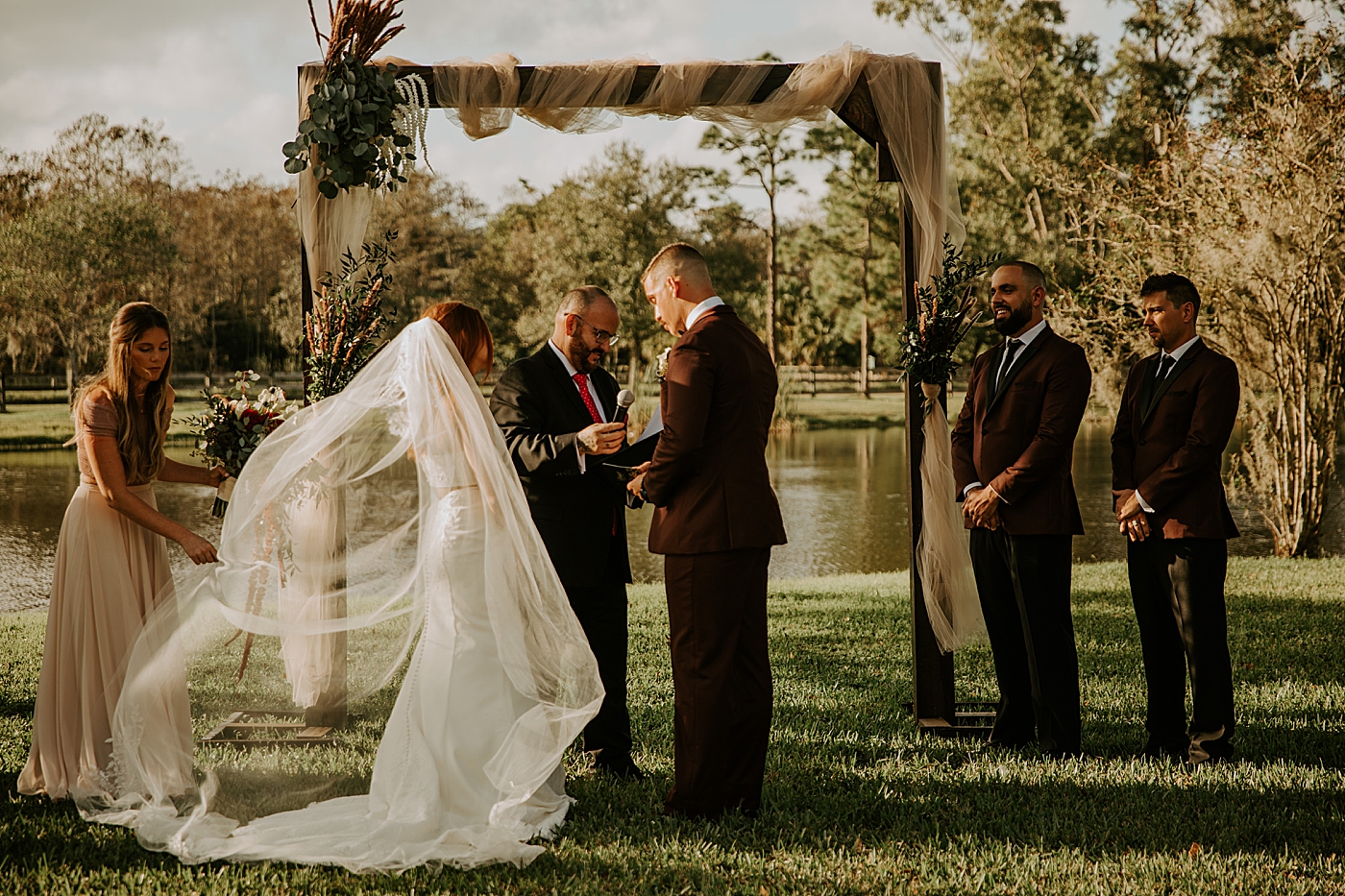 Bride and Groom exchanging vows Bride entering ceremony with father BMR Stables Wedding Photography captured by South Florida Wedding Photographer Maggie Alvarez Photography