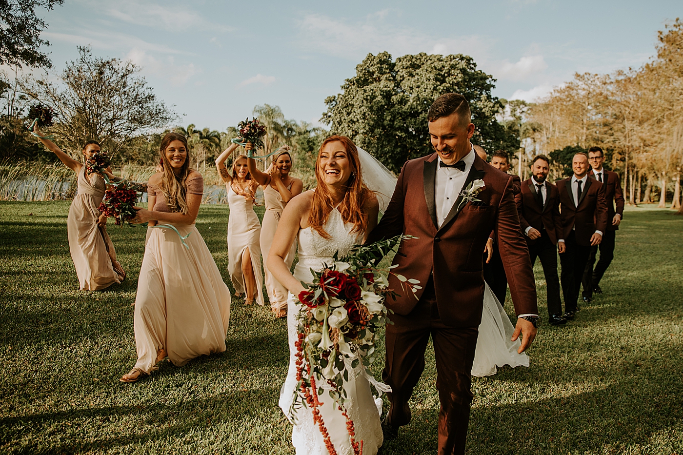 Bride and Groom walking with Bridal Party following them Bride entering ceremony with father BMR Stables Wedding Photography captured by South Florida Wedding Photographer Maggie Alvarez Photography
