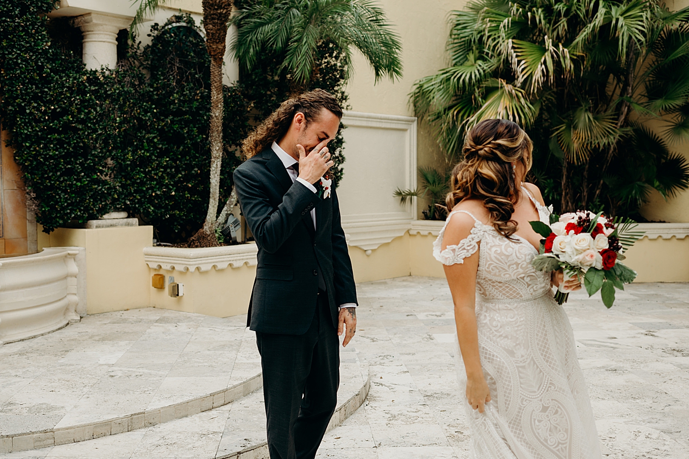 Groom emotional reaction to seeing Bride with white and red bouquet Benvenuto Restaurant Wedding Photography captured by South Florida Wedding Photographer Maggie Alvarez Photography