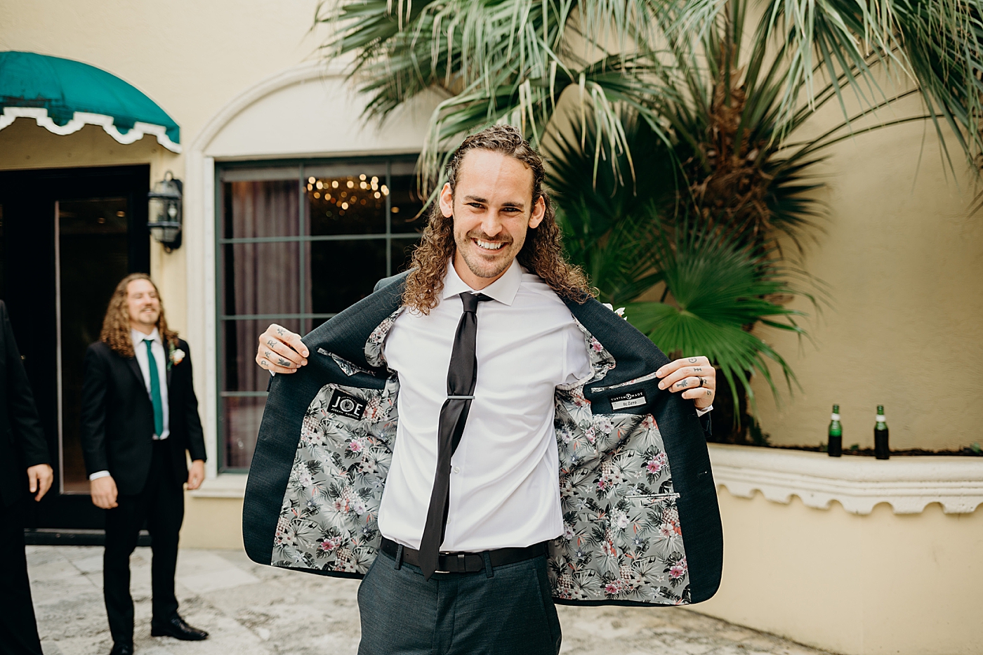 Groom showing off inner lacing of jacket getting ready Benvenuto Restaurant Wedding Photography captured by South Florida Wedding Photographer Maggie Alvarez Photography