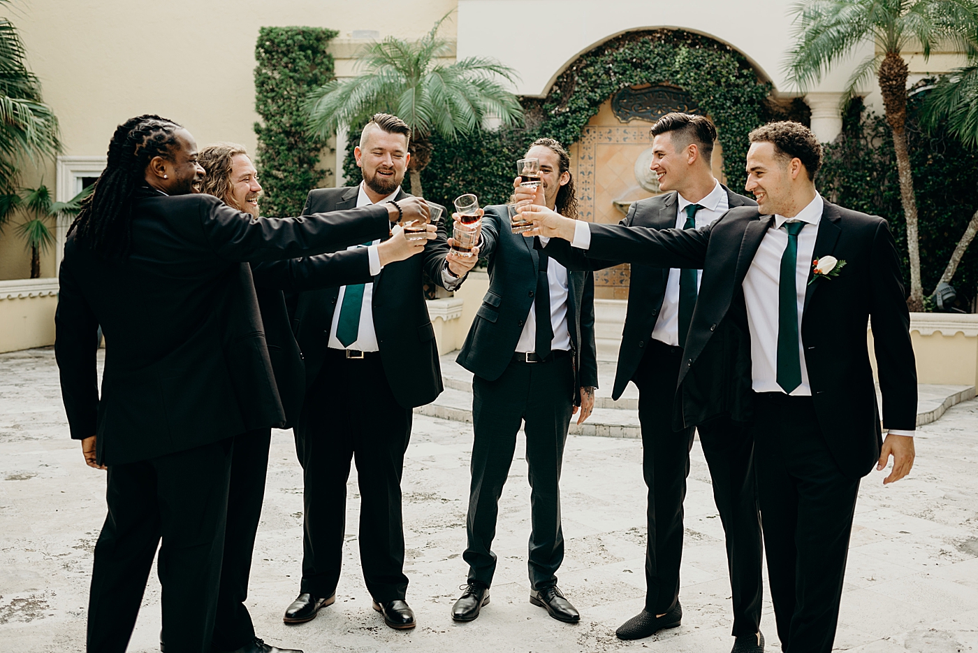 Groom and groomsmen getting ready having a drink Benvenuto Restaurant Wedding Photography captured by South Florida Wedding Photographer Maggie Alvarez Photography