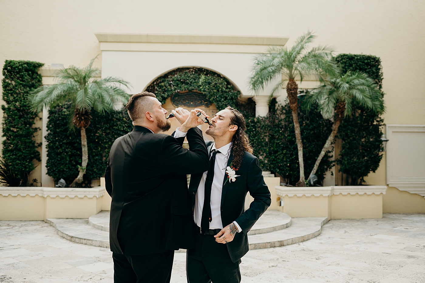 Groom and groomsmen having a drink interlocked arms Benvenuto Restaurant Wedding Photography captured by South Florida Wedding Photographer Maggie Alvarez Photography