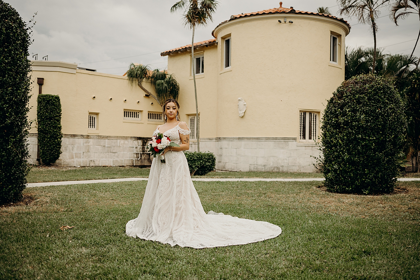 Portrait of Bride with red and white bouquet Benvenuto Restaurant Wedding Photography captured by South Florida Wedding Photographer Maggie Alvarez Photography