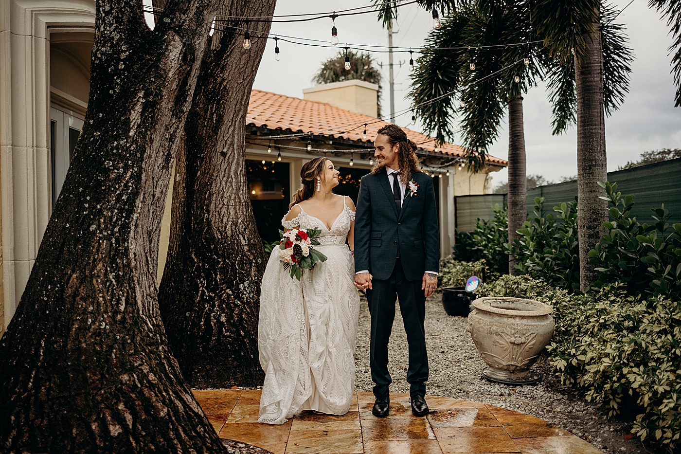 Bride and Groom looking at each other holding hands Benvenuto Restaurant Wedding Photography captured by South Florida Wedding Photographer Maggie Alvarez Photography
