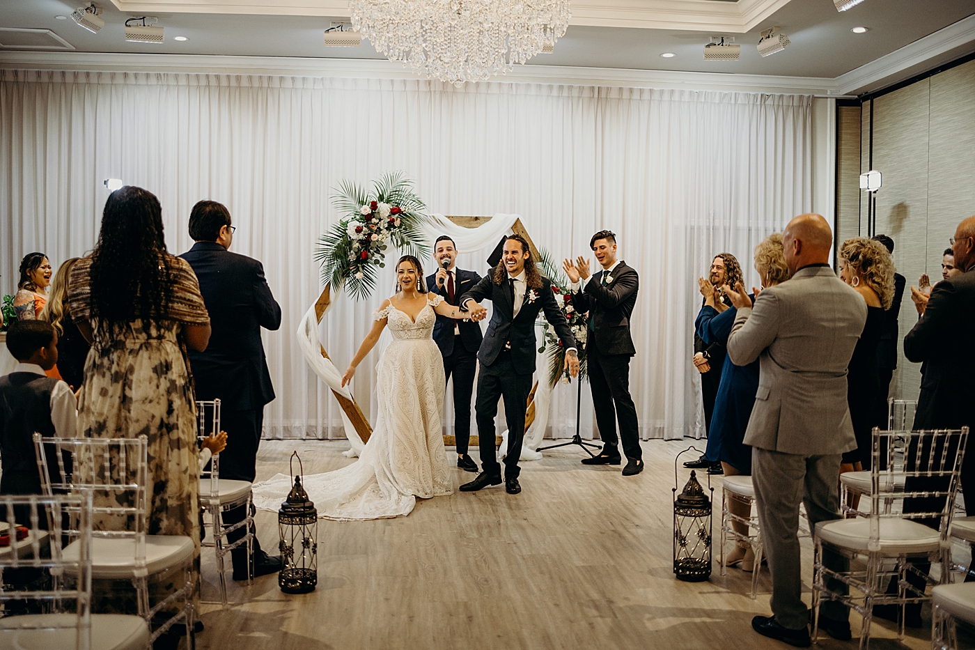 Bride and Groom just married starting to exit ceremony with clapping audience Benvenuto Restaurant Wedding Photography captured by South Florida Wedding Photographer Maggie Alvarez Photography