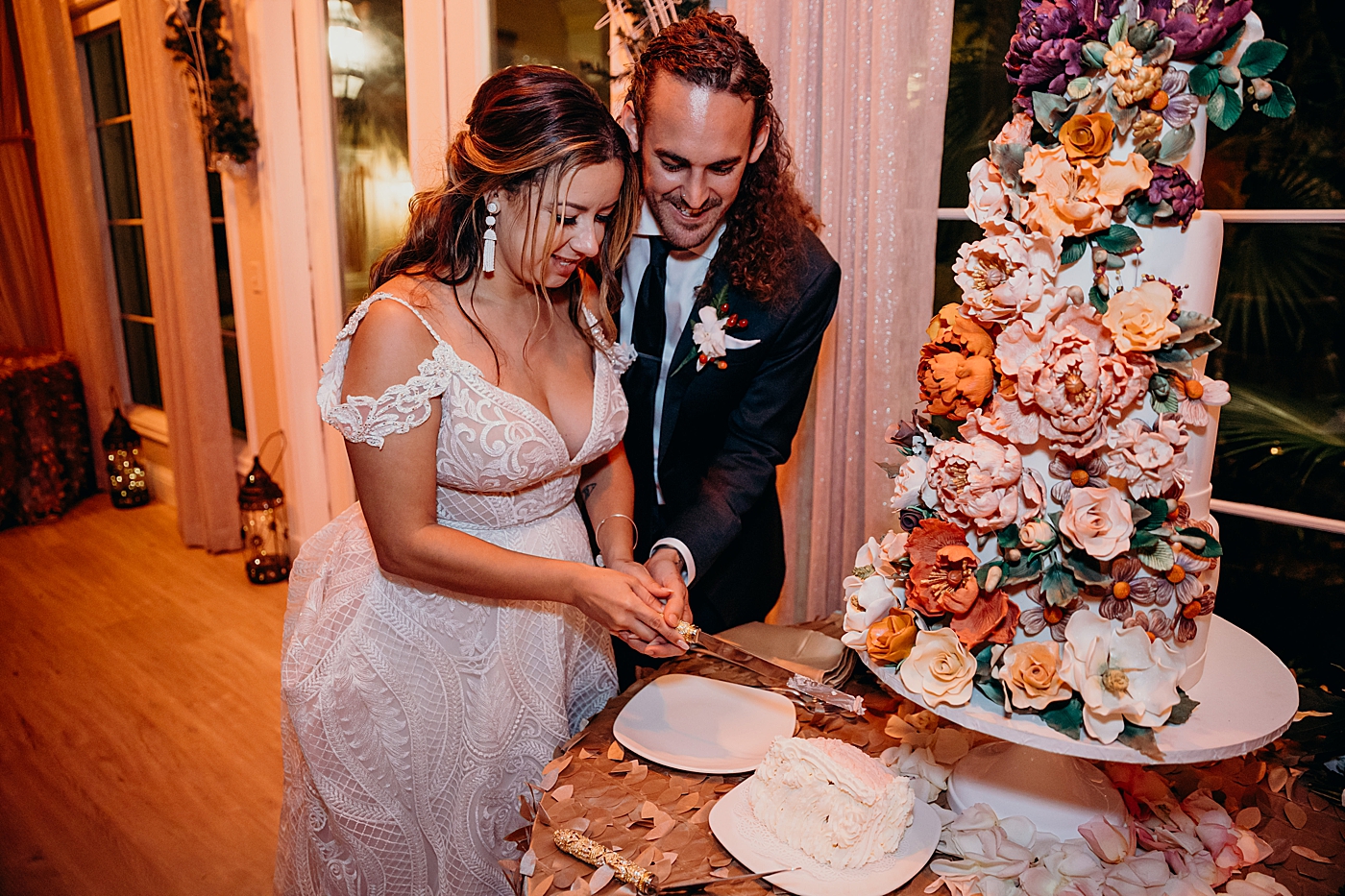 Bride and Groom cutting floral wedding cake Benvenuto Restaurant Wedding Photography captured by South Florida Wedding Photographer Maggie Alvarez Photography