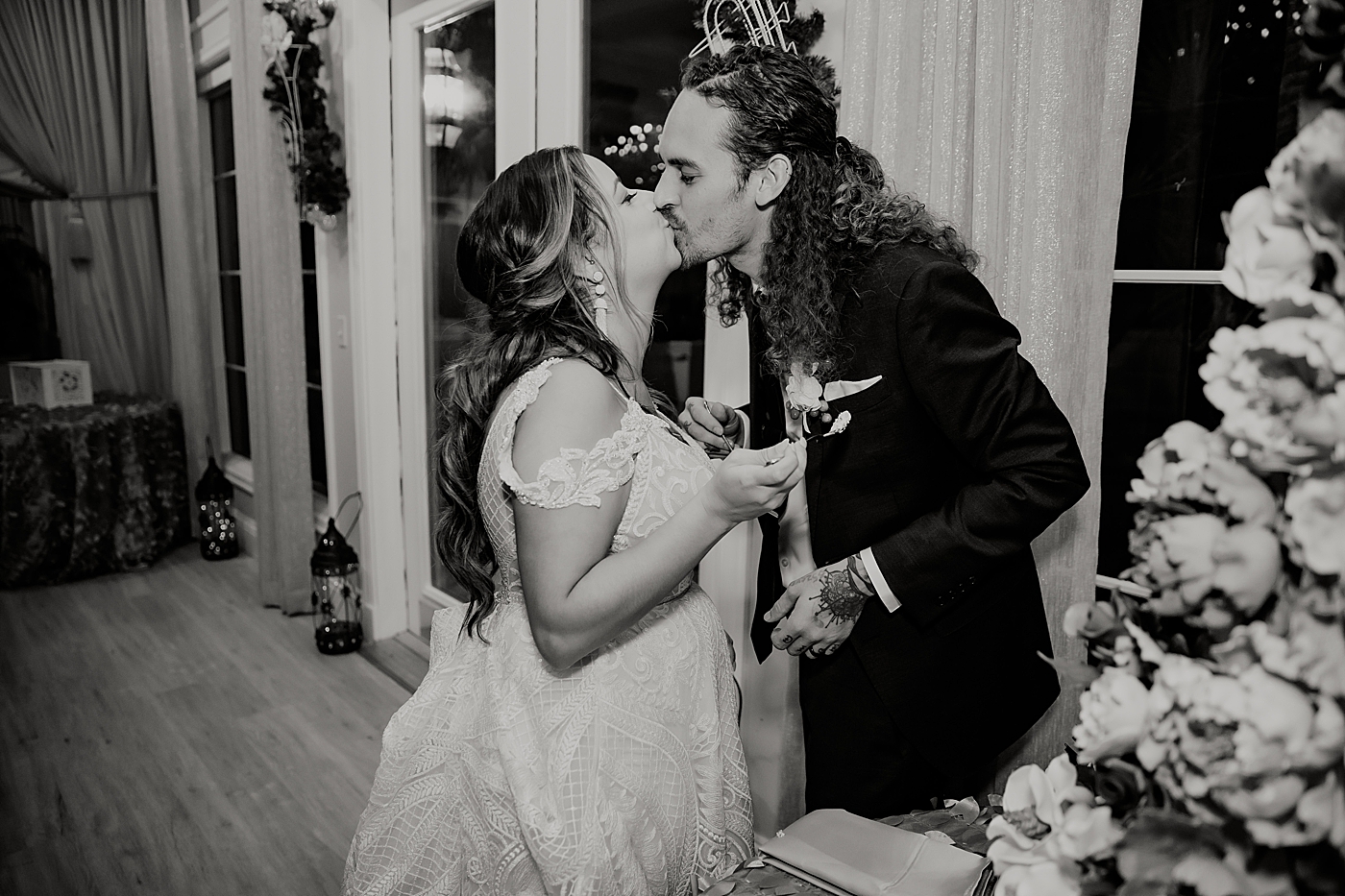 B&W Bride and Groom kissing after cake cutting Benvenuto Restaurant Wedding Photography captured by South Florida Wedding Photographer Maggie Alvarez Photography