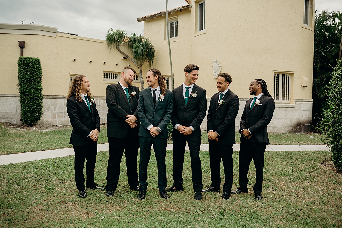 Groom and groomsmen with arms in formal position Benvenuto Restaurant Wedding Photography captured by South Florida Wedding Photographer Maggie Alvarez Photography