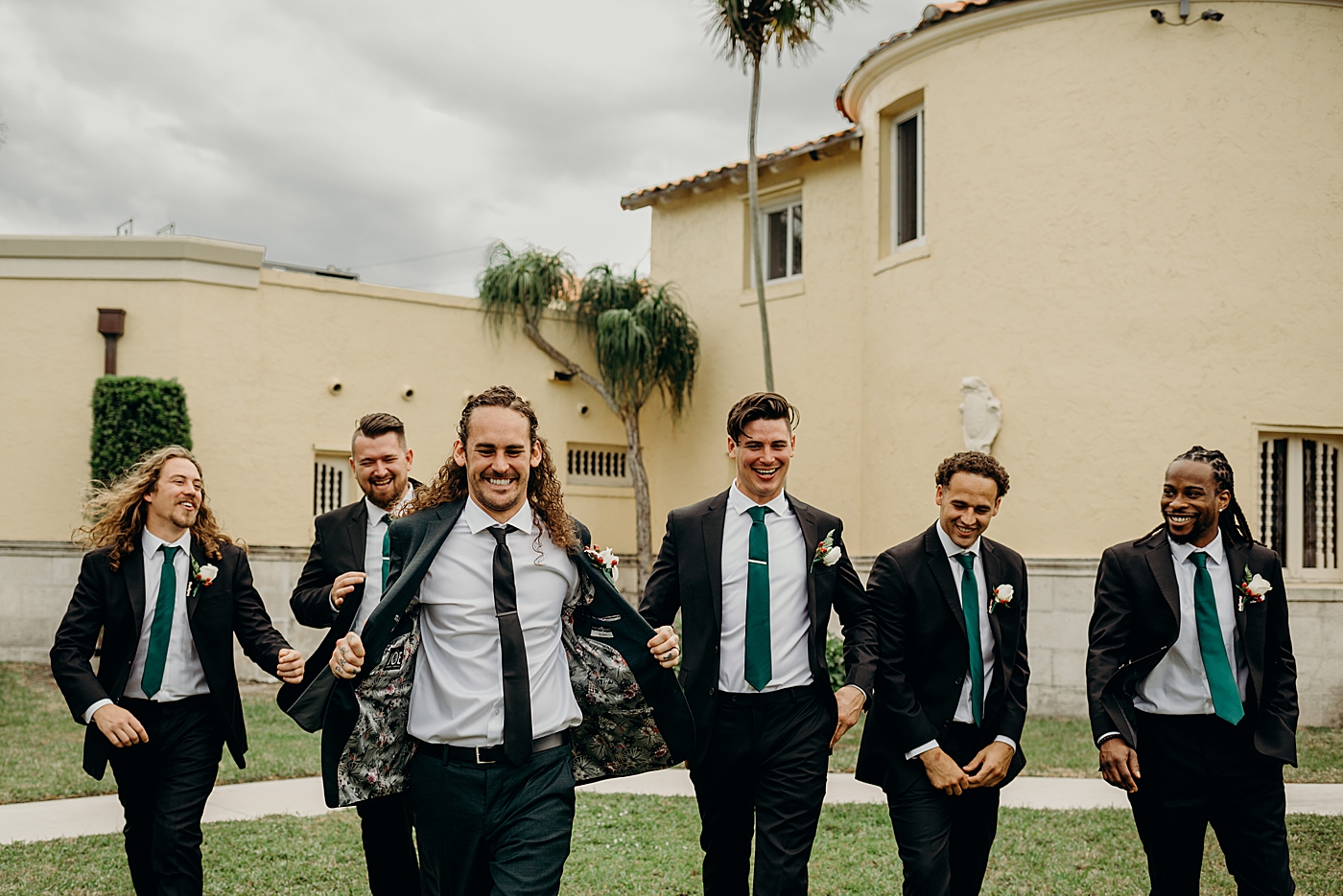 Casual portrait of groom and Groomsmen approaching Benvenuto Restaurant Wedding Photography captured by South Florida Wedding Photographer Maggie Alvarez Photography