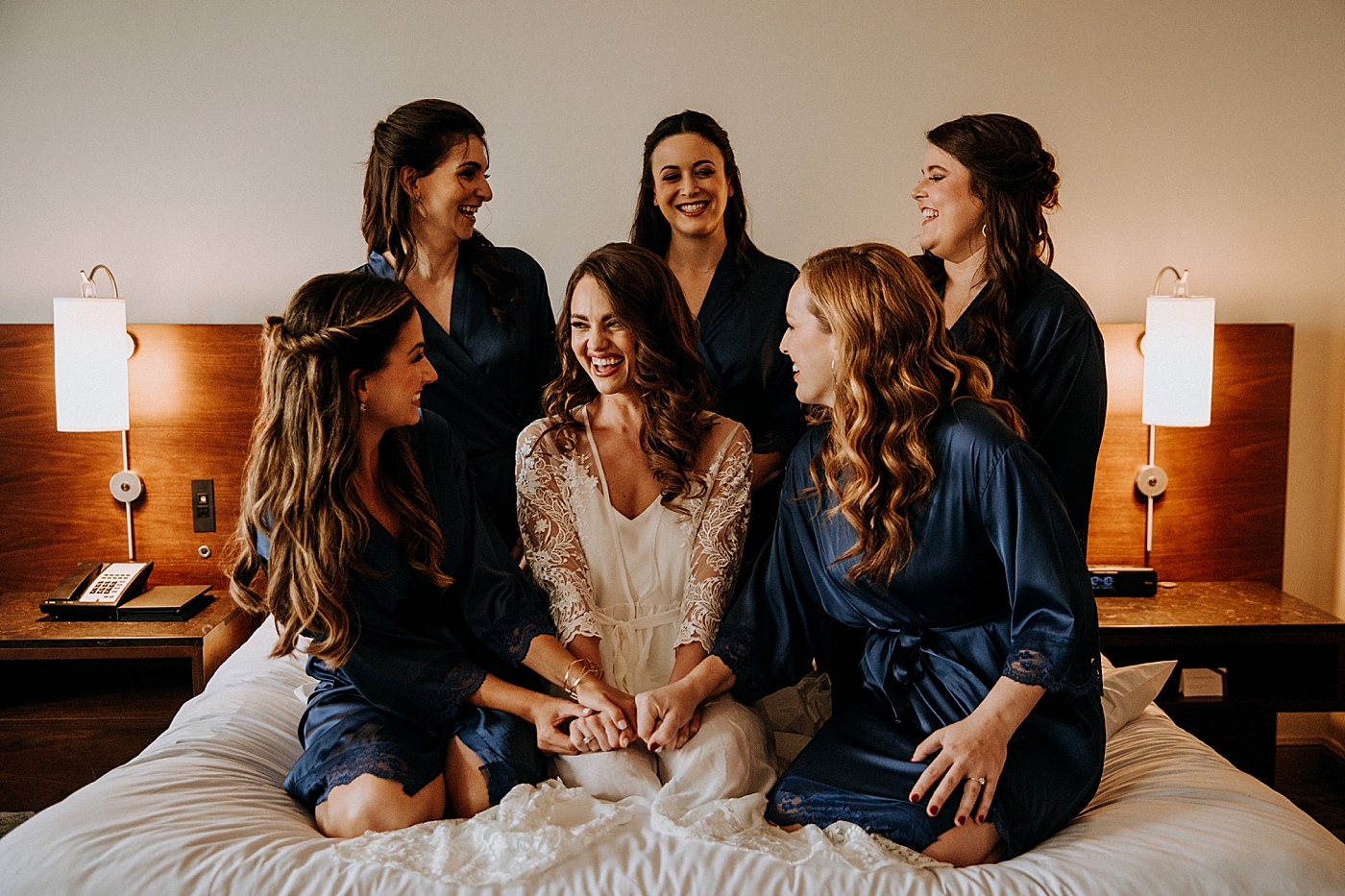 Bride getting ready with Bridesmaids in silk robes Coral Gables Country Club Wedding Photography captured by South Florida Wedding Photographer Maggie Alvarez Photography