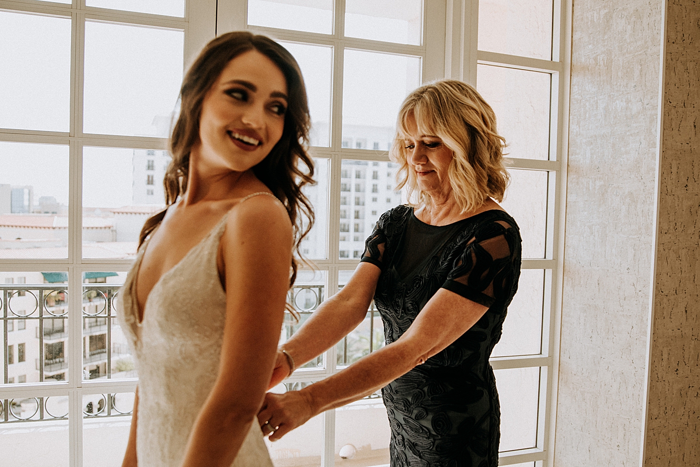 Mother helping bride put on Dress Getting Ready Coral Gables Country Club Wedding Photography captured by South Florida Wedding Photographer Maggie Alvarez Photography
