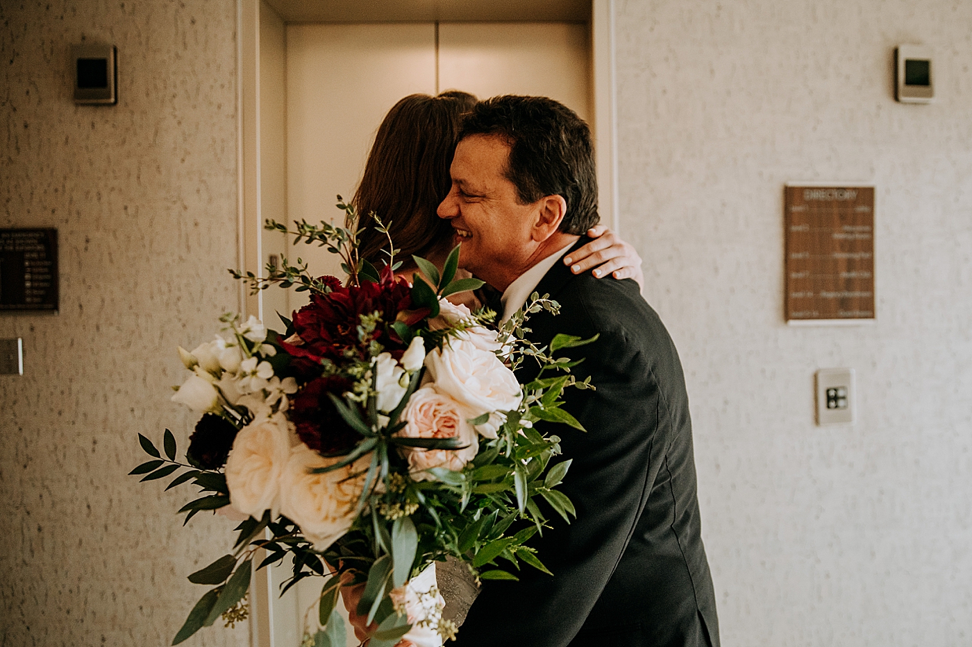 Father hugging Bride holding Dark Red Bouquet Coral Gables Country Club Wedding Photography captured by South Florida Wedding Photographer Maggie Alvarez Photography