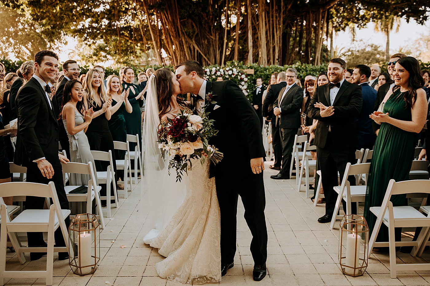 Bride and Groom kissing halfway down the aisle Coral Gables Country Club Wedding Photography captured by South Florida Wedding Photographer Maggie Alvarez Photography
