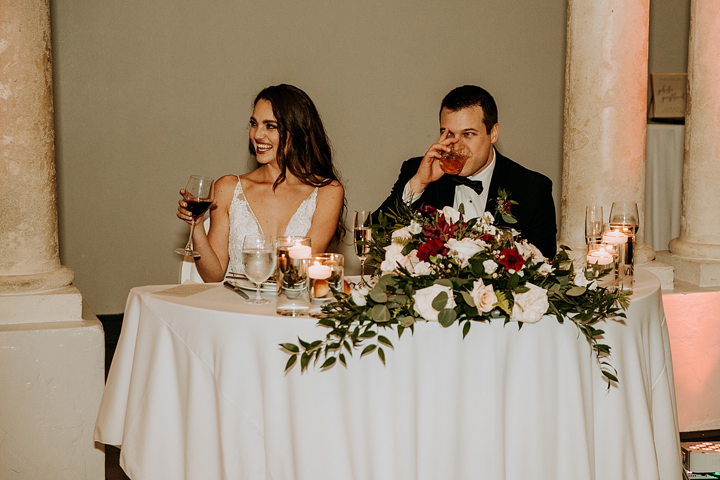 Bride and Groom at Sweetheart table having a drink Coral Gables Country Club Wedding Photography captured by South Florida Wedding Photographer Maggie Alvarez Photography