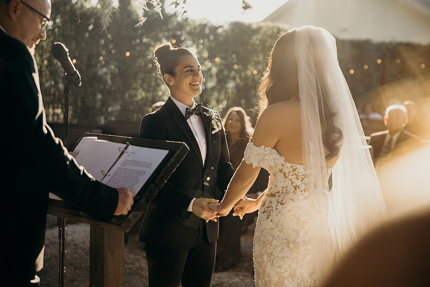 Couple looking into each others eyes with bright sun reflections Ceremony Ever After Farms Wedding Photography captured by South Florida Wedding Photographer Maggie Alvarez Photography