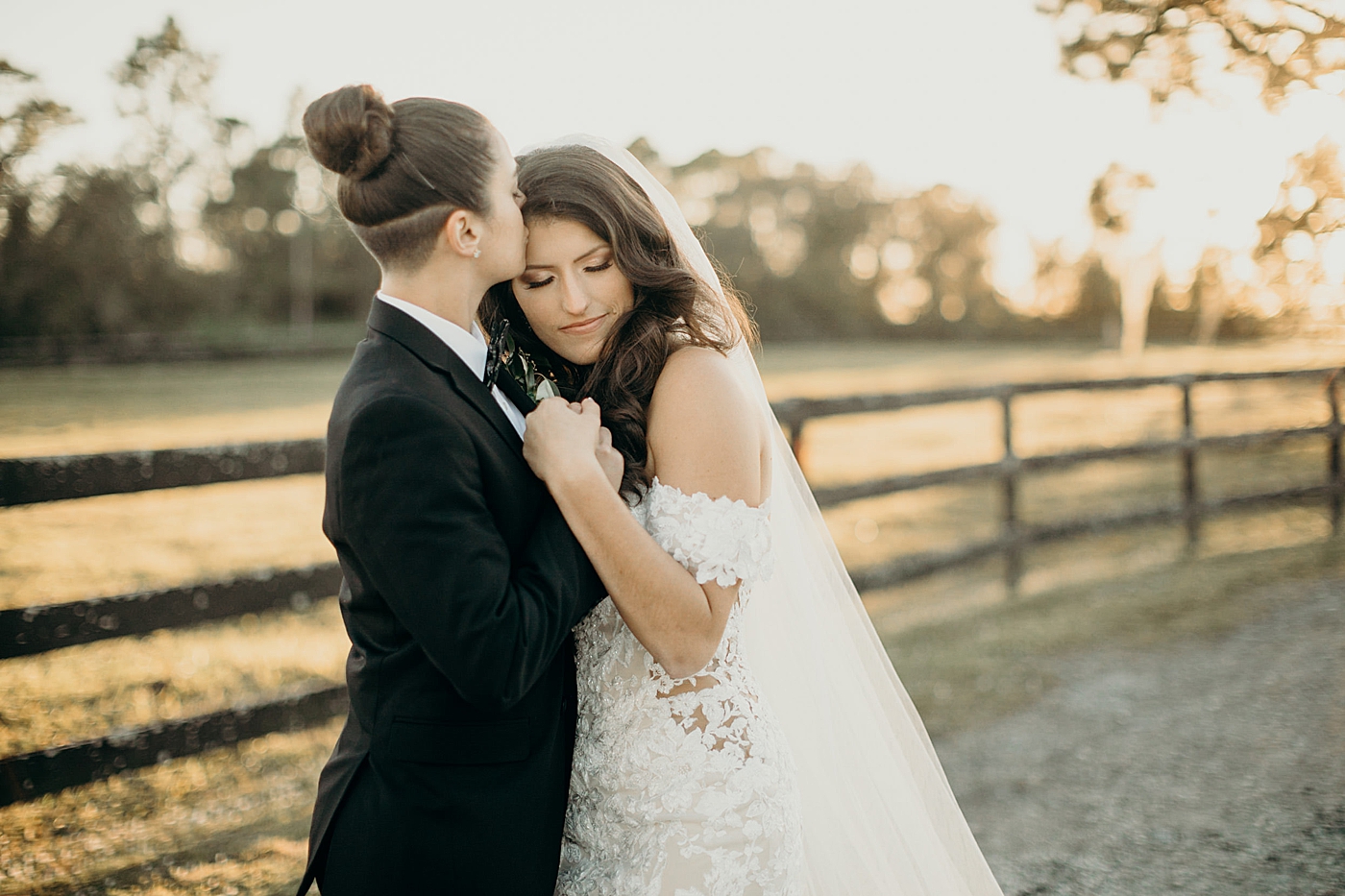 Bride kissing Bride on forehead hugging each other Ever After Farms Wedding Photography captured by South Florida Wedding Photographer Maggie Alvarez Photography