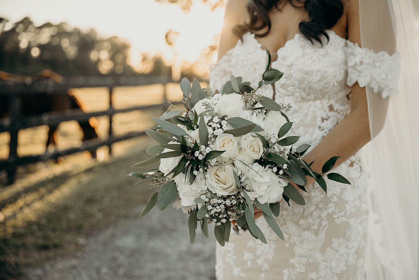 Closeup detail shot of Bride's white bouquet with horse in background Ever After Farms Wedding Photography captured by South Florida Wedding Photographer Maggie Alvarez Photography