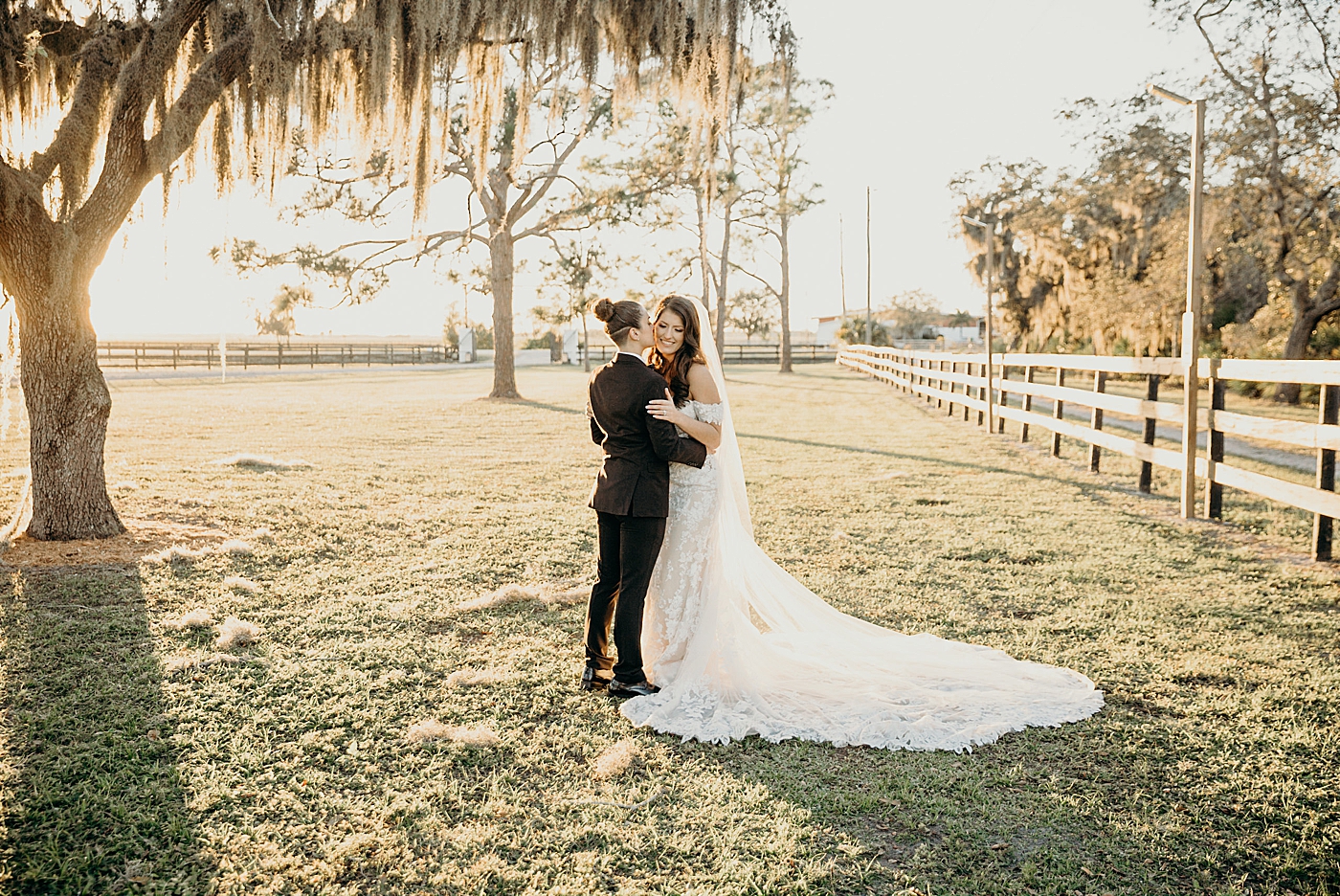Couple holding each other out on farm field Ever After Farms Wedding Photography captured by South Florida Wedding Photographer Maggie Alvarez Photography