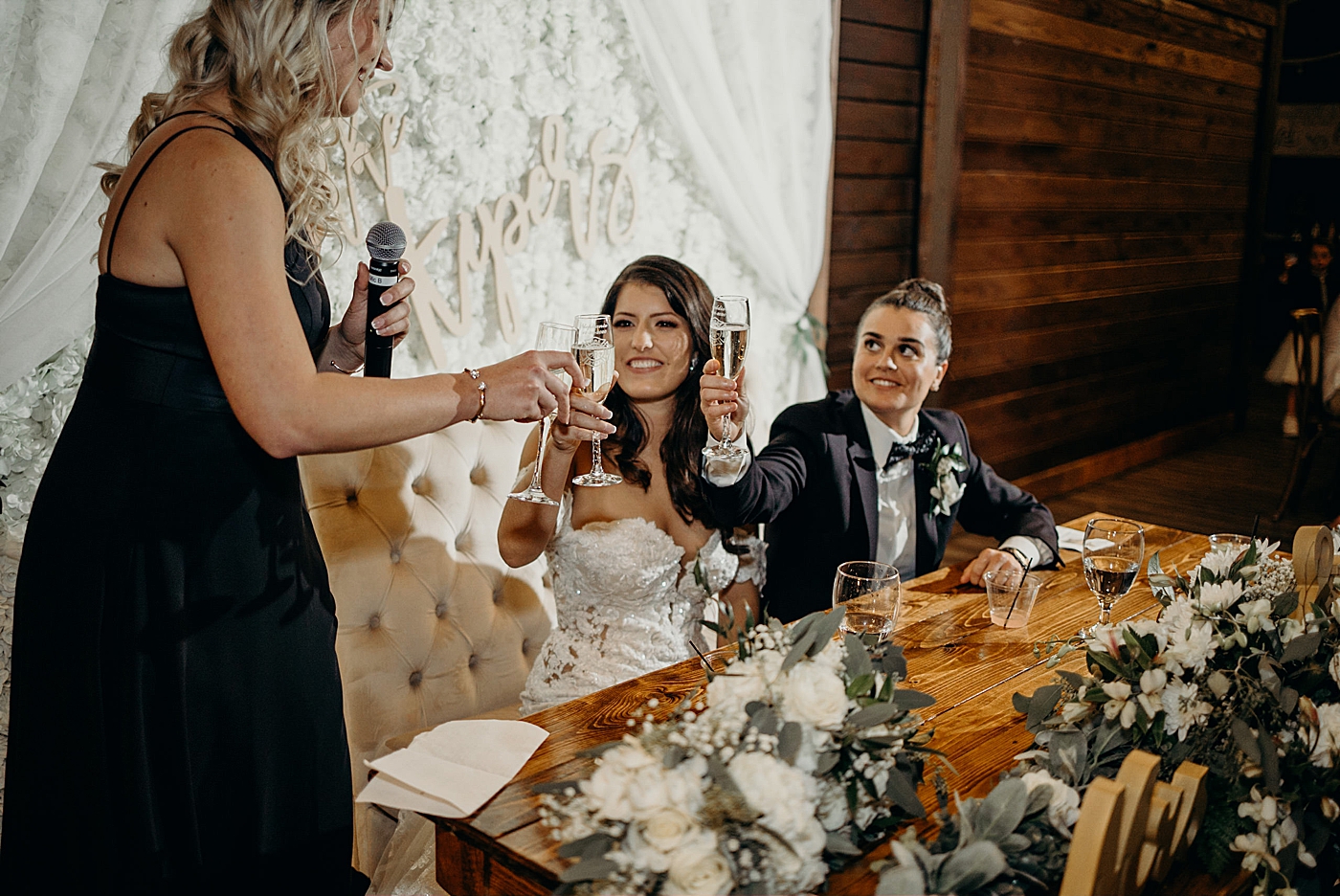 Cheers by the sweetheart table with couple Ever After Farms Wedding Photography captured by South Florida Wedding Photographer Maggie Alvarez Photography