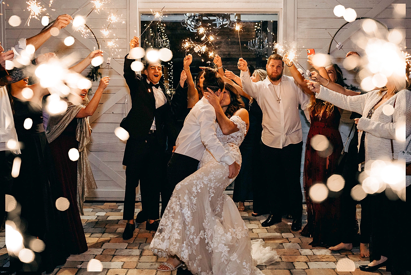 Brides dipping and kissing for exit with sparklers Ever After Farms Wedding Photography captured by South Florida Wedding Photographer Maggie Alvarez Photography