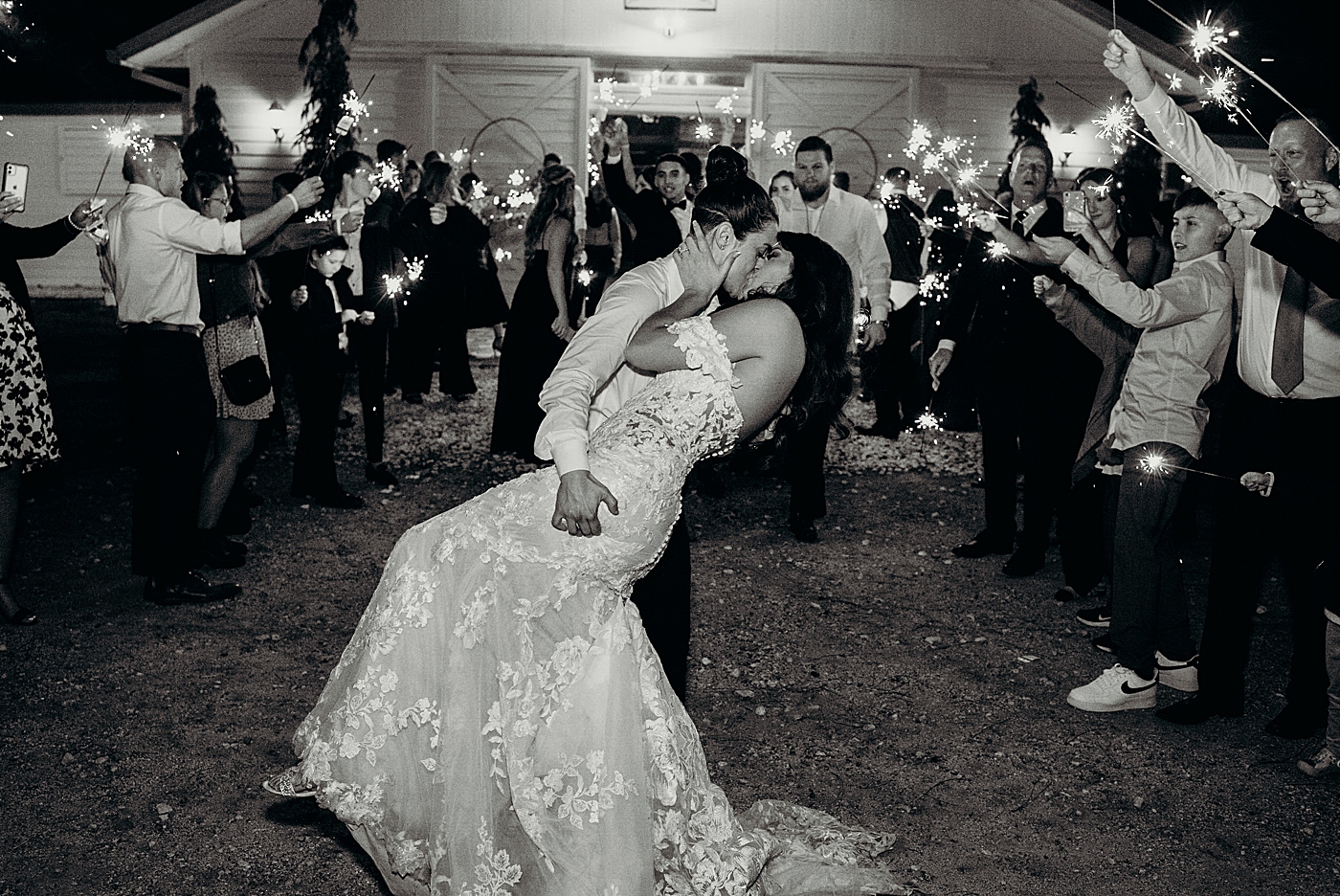 Black and white couple dipping and kissing at exit with Sparklers Ever After Farms Wedding Photography captured by South Florida Wedding Photographer Maggie Alvarez Photography