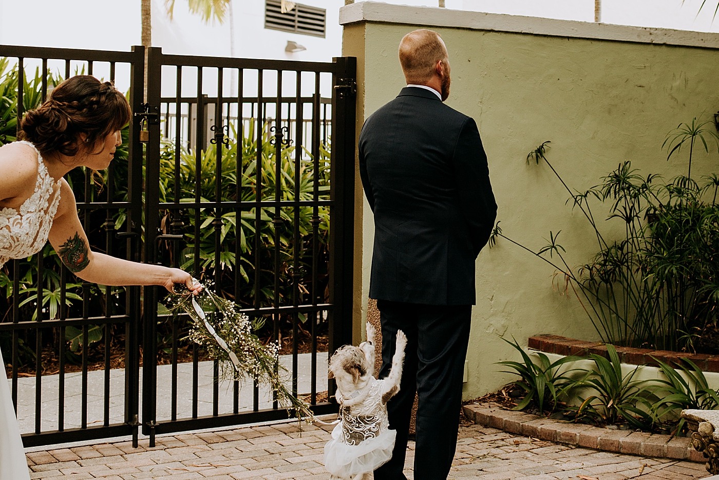 First Look with wedding dog Historic Stranahan House Wedding Photography captured by South Florida Wedding Photographer Maggie Alvarez Photography
