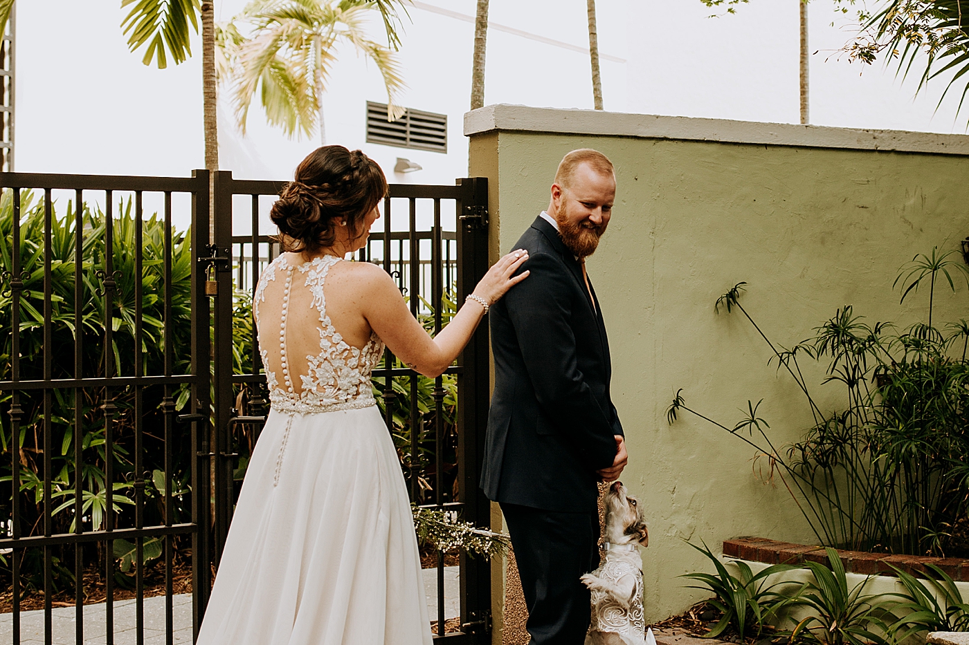 First Look reaction with dog Historic Stranahan House Wedding Photography captured by South Florida Wedding Photographer Maggie Alvarez Photography