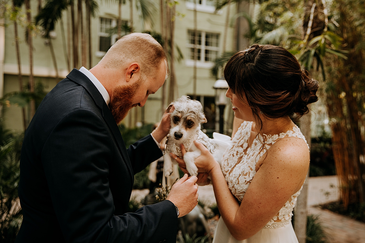 Bride and Groom doting over dog Historic Stranahan House Wedding Photography captured by South Florida Wedding Photographer Maggie Alvarez Photography