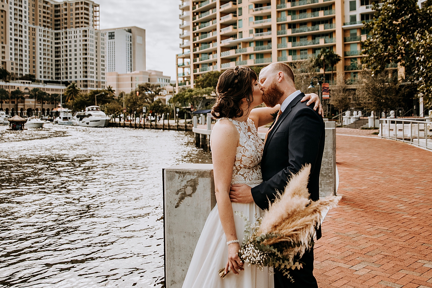 Bride and Groom kissing each other by the waterside Historic Stranahan House Wedding Photography captured by South Florida Wedding Photographer Maggie Alvarez Photography