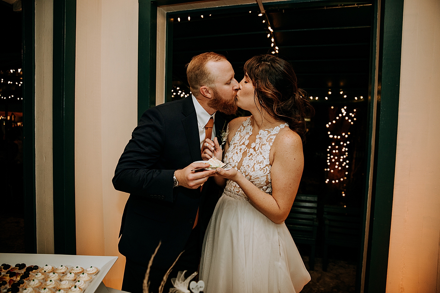 Bride and Groom kissing after cake cutting Historic Stranahan House Wedding Photography captured by South Florida Wedding Photographer Maggie Alvarez Photography