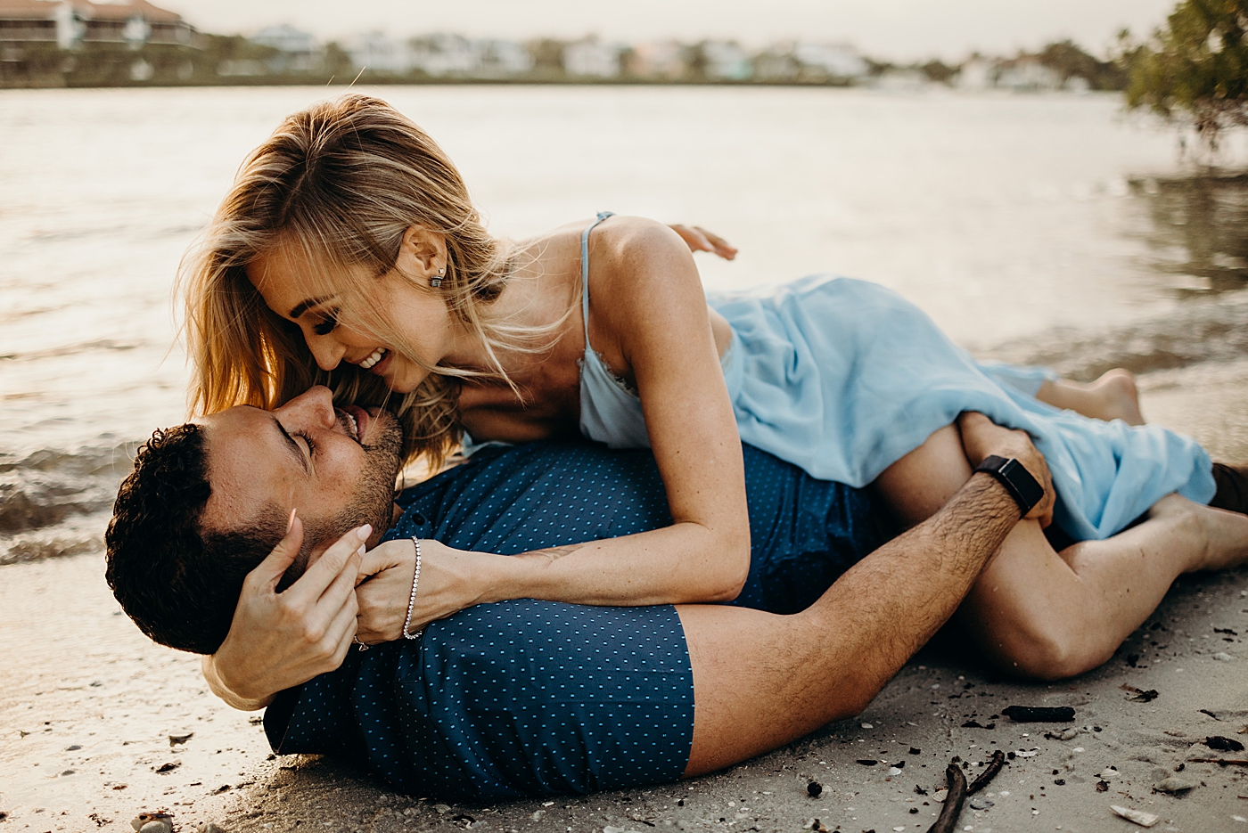 Man laying on beach Coral Cove Park Engagement Photography captured by Maggie Alvarez Photography