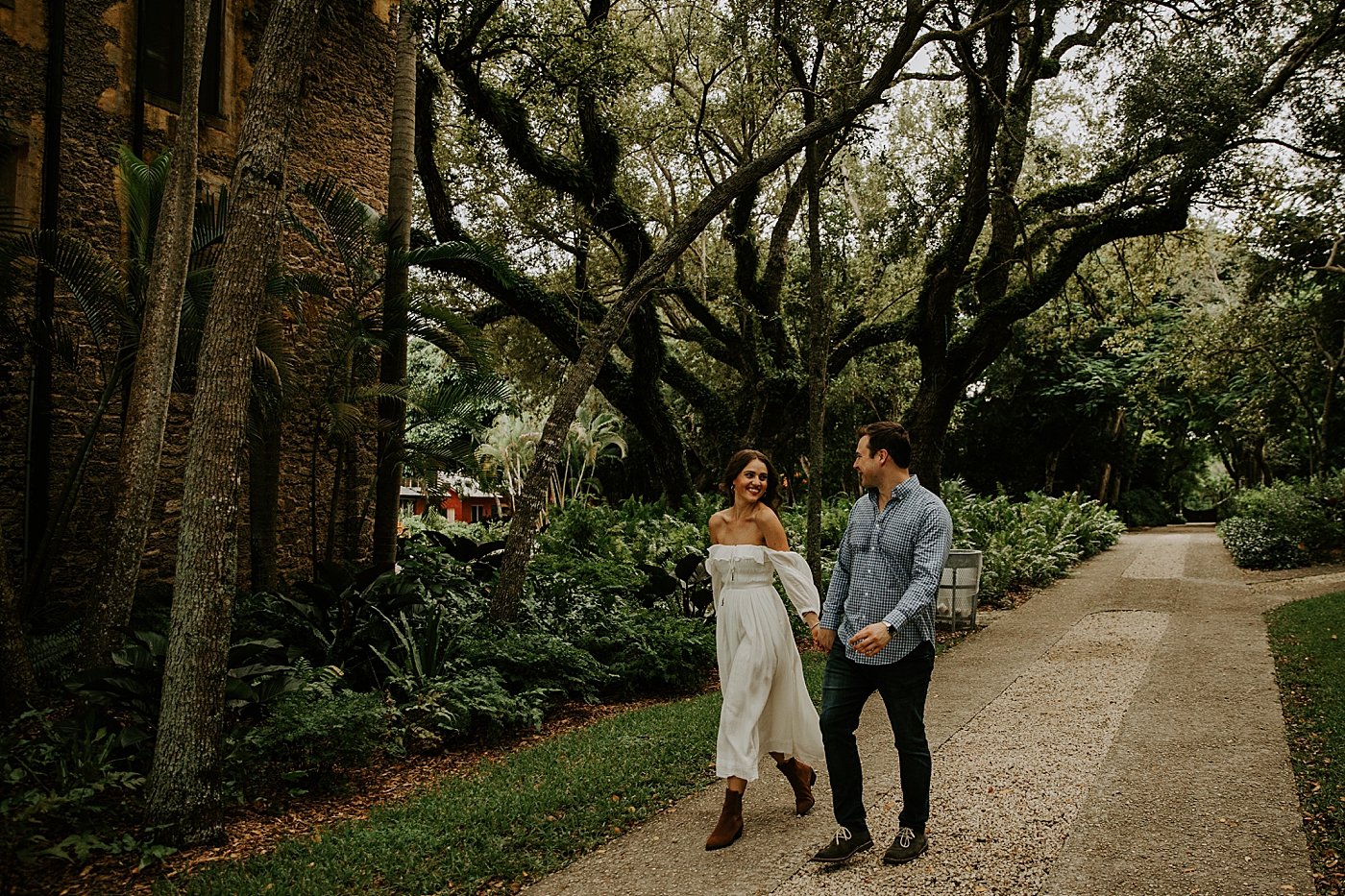 Couple holding hands and walking on trail Deering Estate Engagement Photography captured by Maggie Alvarez Photography