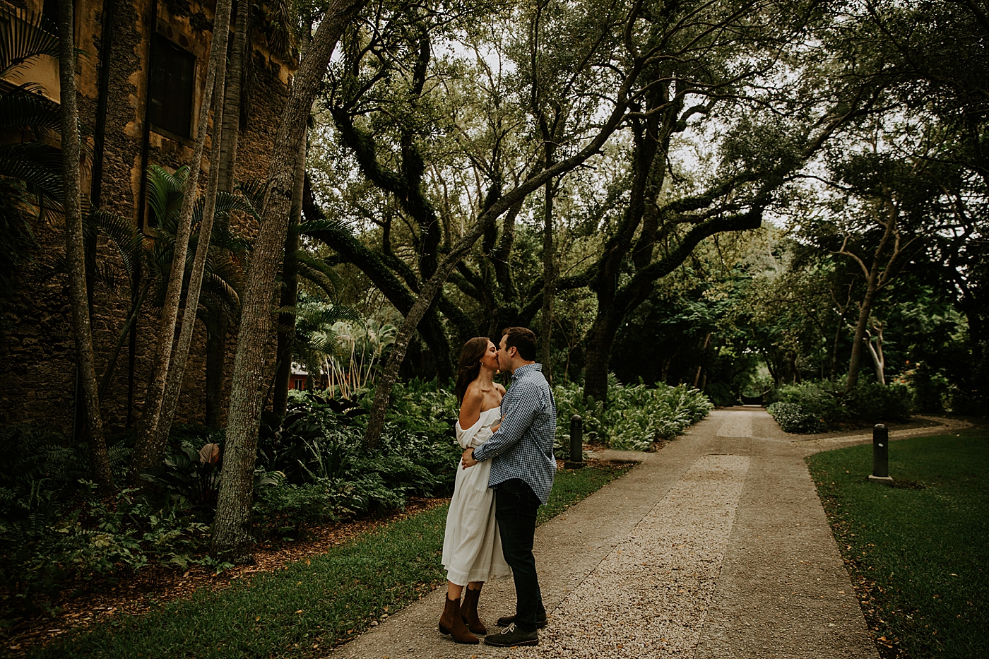 Couple kissing each other in green enviroment Deering Estate Engagement Photography captured by Maggie Alvarez Photography