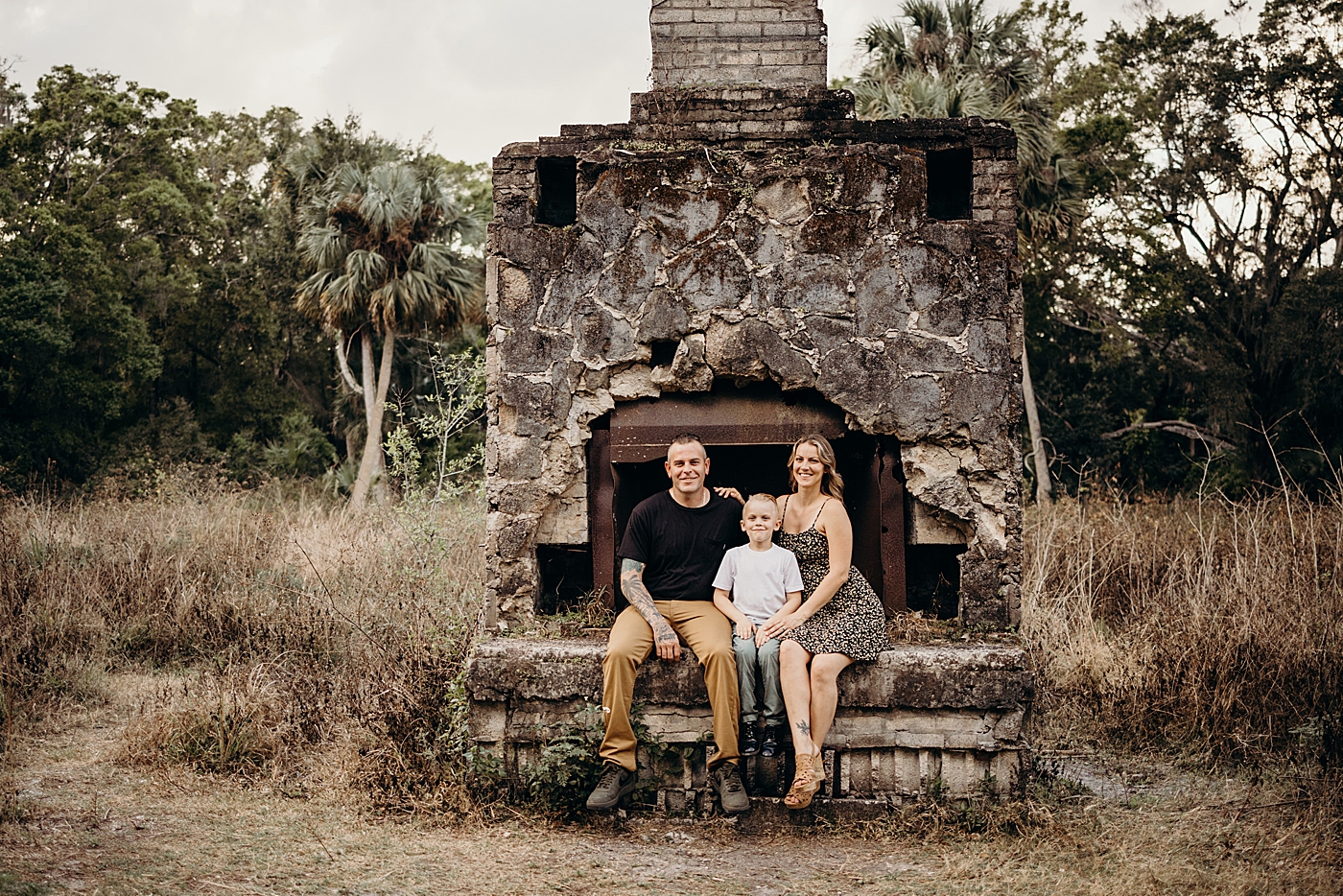 Family sitting of ruin of fireplace Park Family Photography by South Florida Family Photographer Maggie Alvarez Photography