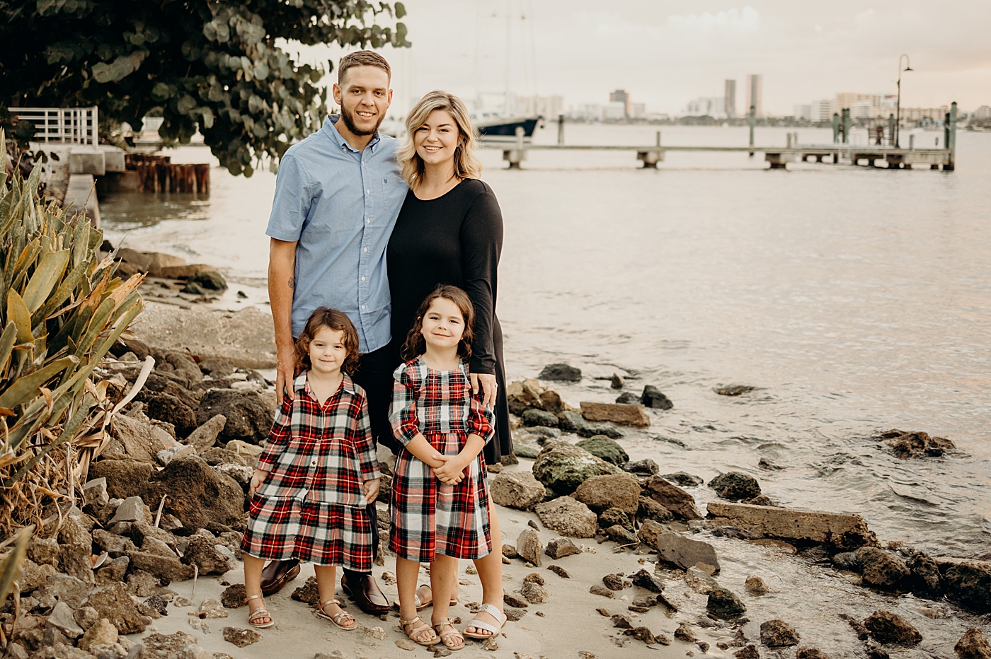 Family portrait standing on rocky sand by the ocean Palm Beach Island Family Photography by South Florida Family Photographer Maggie Alvarez Photography