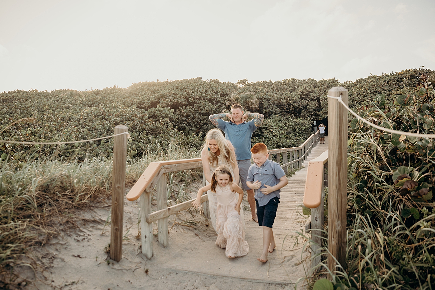 Family running onto the beach together Ocean Ridge Hammock Park Family Photography by South Florida Family Photographer Maggie Alvarez Photography