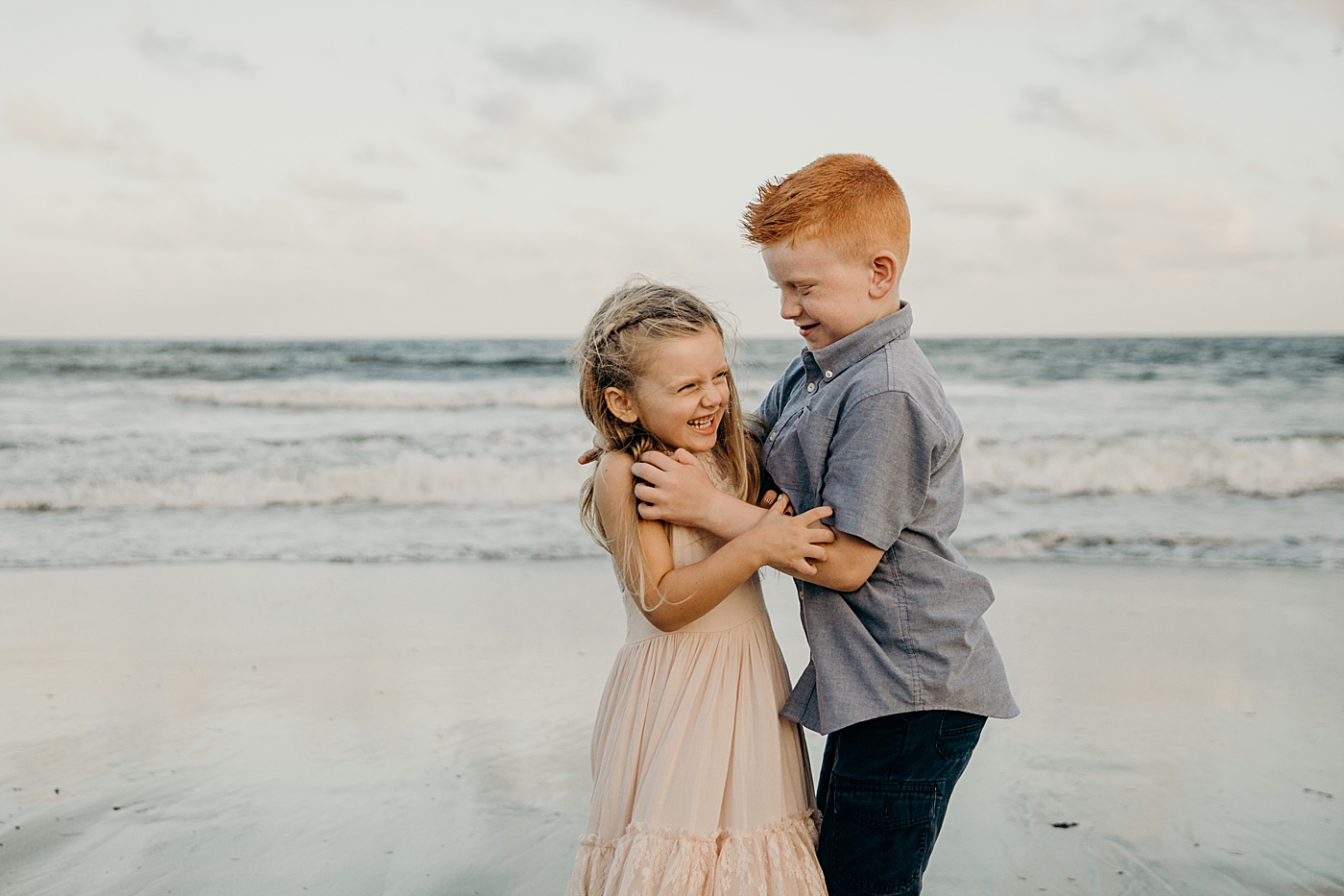 Brother and sister rough housing by the beach water Ocean Ridge Hammock Park Family Photography by South Florida Family Photographer Maggie Alvarez Photography