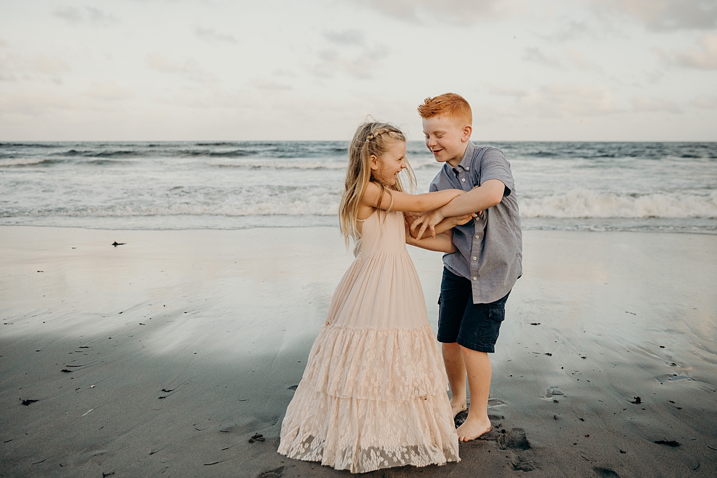 Kids playing with waves coming in on the beach Ocean Ridge Hammock Park Family Photography by South Florida Family Photographer Maggie Alvarez Photography