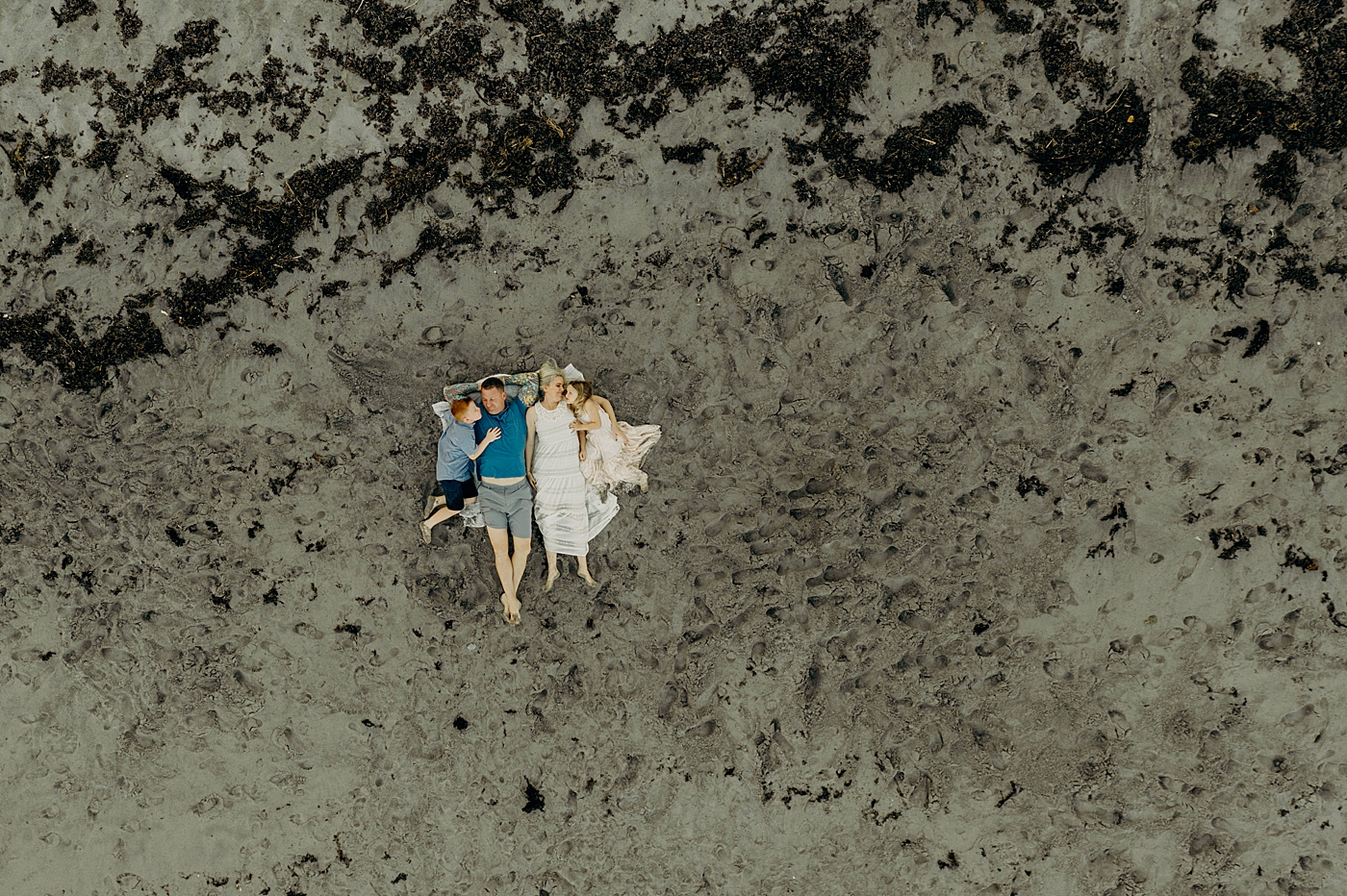 Drone shot of family laying down on beach Ocean Ridge Hammock Park Family Photography by South Florida Family Photographer Maggie Alvarez Photography