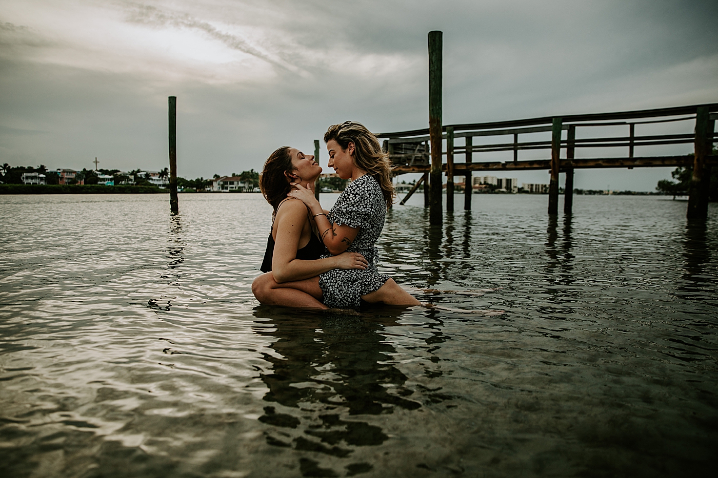 Couple holding each other in calm water South Florida LGBTQ+ Engagement Photography captured by Maggie Alvarez Photography
