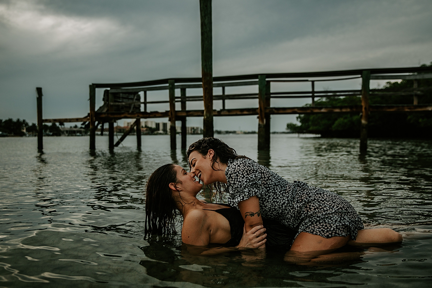 Couple kissing each other in shallow water South Florida LGBTQ+ Engagement Photography captured by Maggie Alvarez Photography