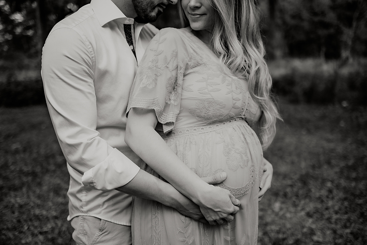 B&W husband holding Wife;s bump from behind Riverbend Park Maternity Photography by South Florida Family Photographer Maggie Alvarez Photography