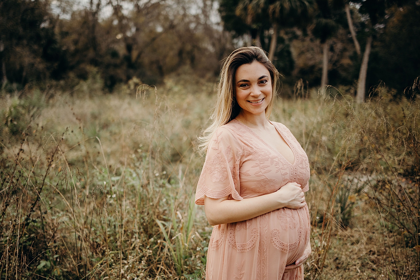Pregnant woman holding her bump Riverbend Park Maternity Photography by South Florida Family Photographer Maggie Alvarez Photography